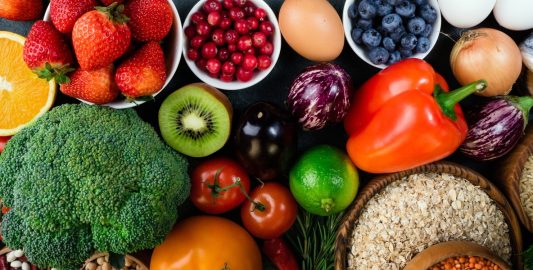 A Bowl Of Fruit And Vegetables On A Table