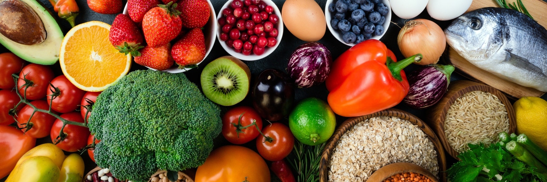 a bowl of fruit and vegetables on a table