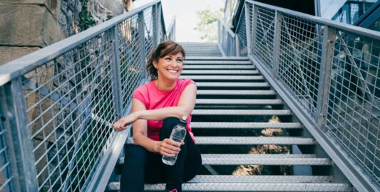 A Person Standing Next To A Fence