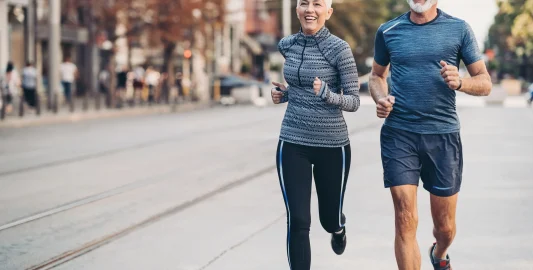 Couple Of Seniors Jogging Outdoors In The City