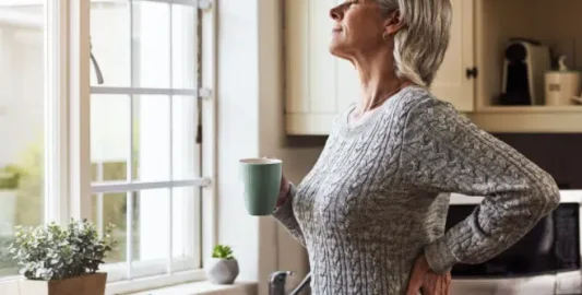 A Person Standing In Front Of A Window