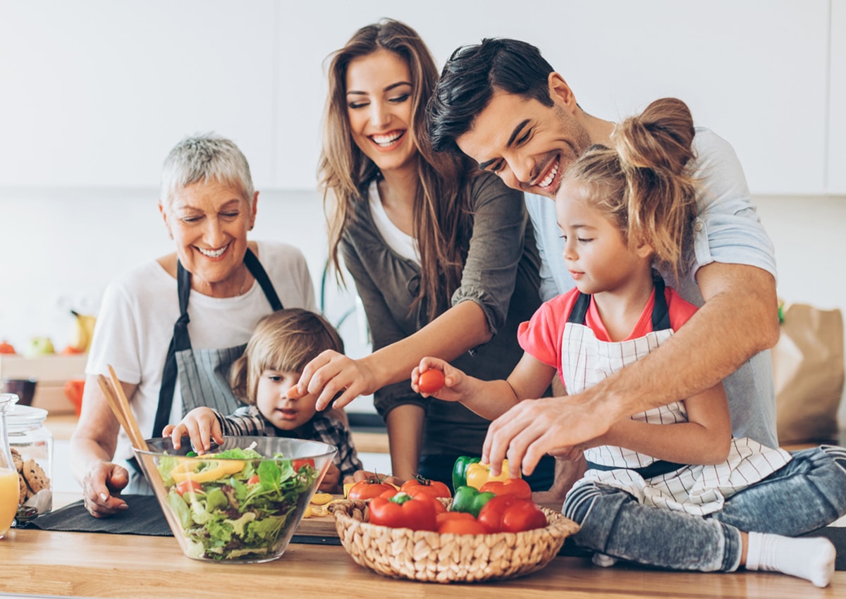 a group of people sitting at a table with food