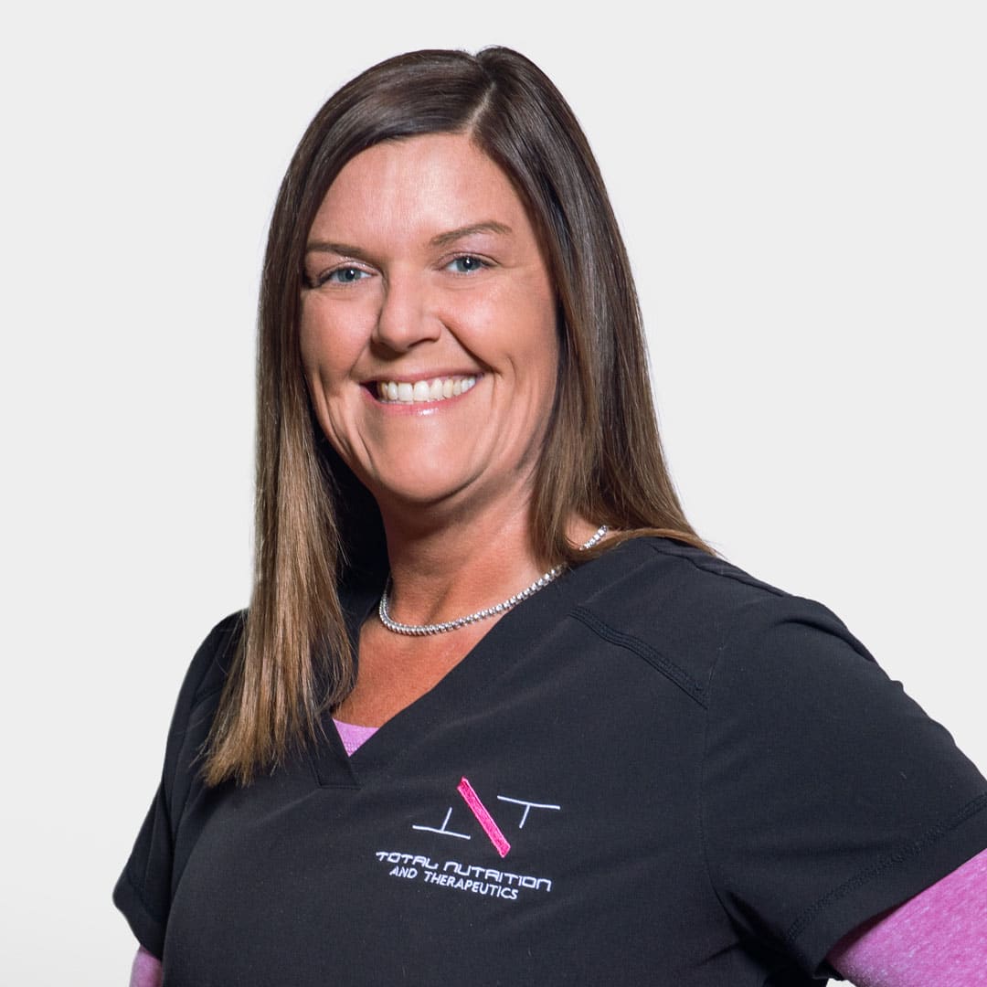 a woman wearing a purple shirt and smiling at the camera