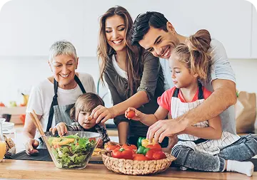 Figure → Family preparing a fresh salad together in the kitchen